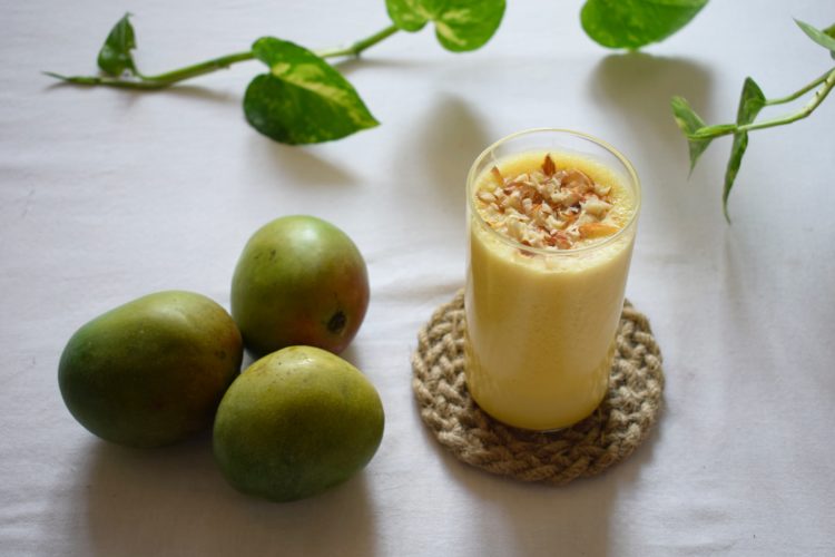 green apple beside clear drinking glass with milk