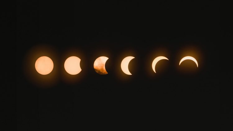 phases of a lunar eclipse next to each other on black background