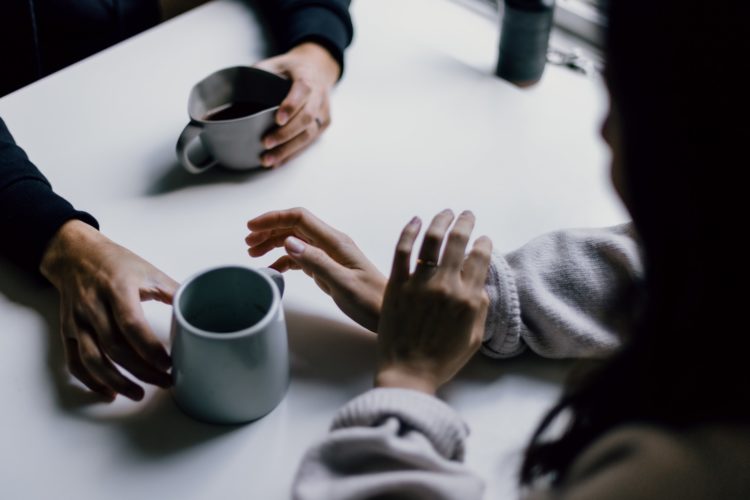 two people sitting down for tea