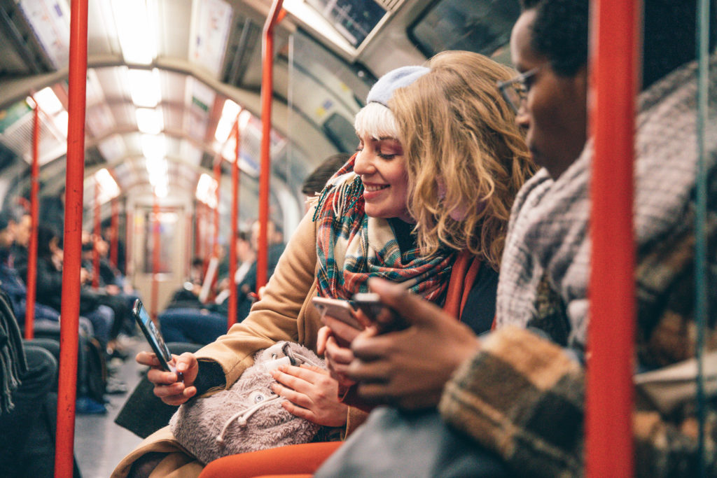 Group of friends commuting by subway in London, UK