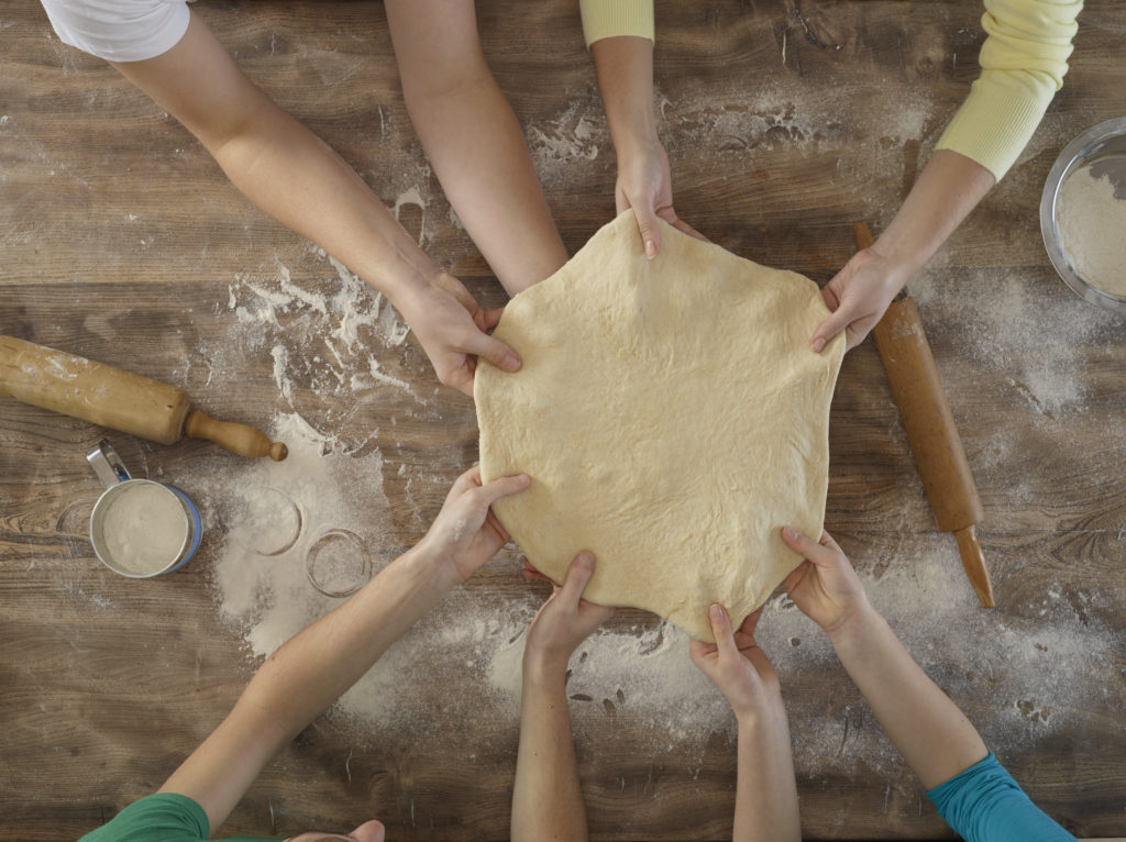 Overhead view of people making bread
