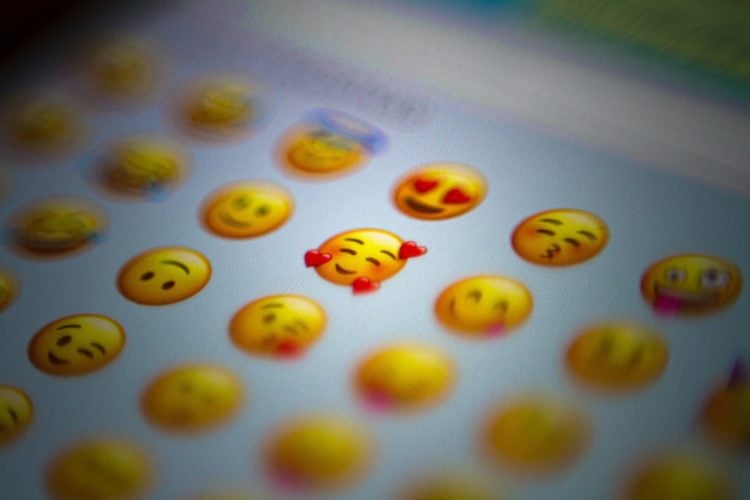 a large group of yellow appls emojis on a blurred screen