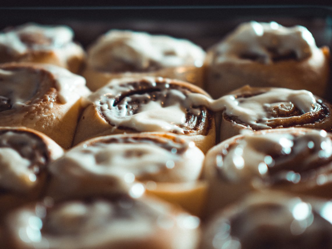 cinnamon rolls on a tray covered in white icing