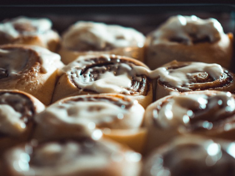 cinnamon rolls on a tray covered in white icing