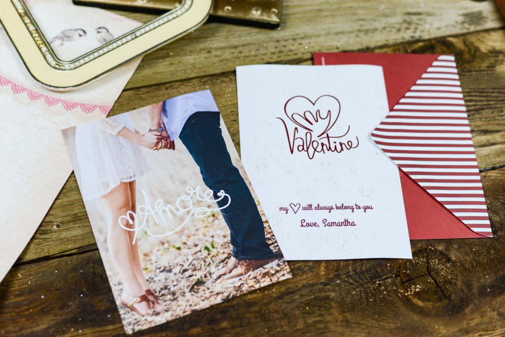two valentines cards on wooden table