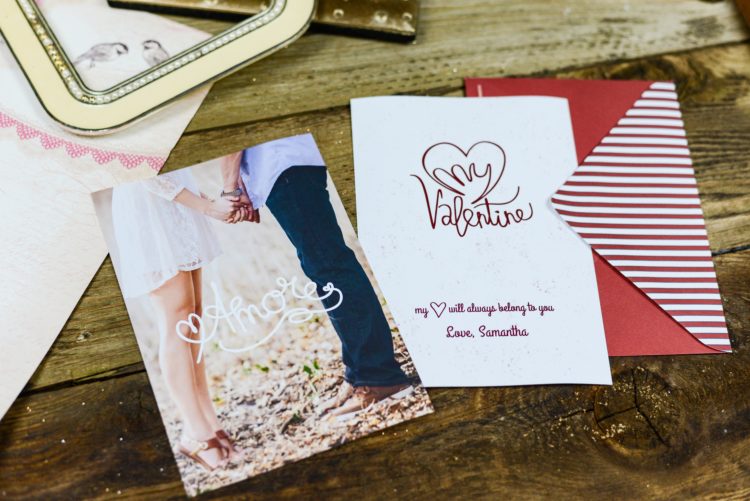 two valentines cards on wooden table