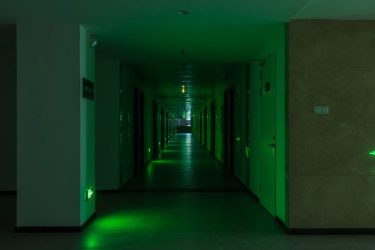 dark empty hallway with green lighting