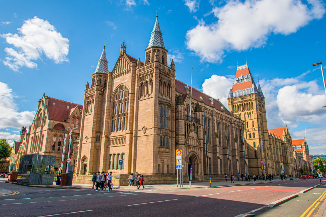 University of Manchester building on street corner on a sunny day