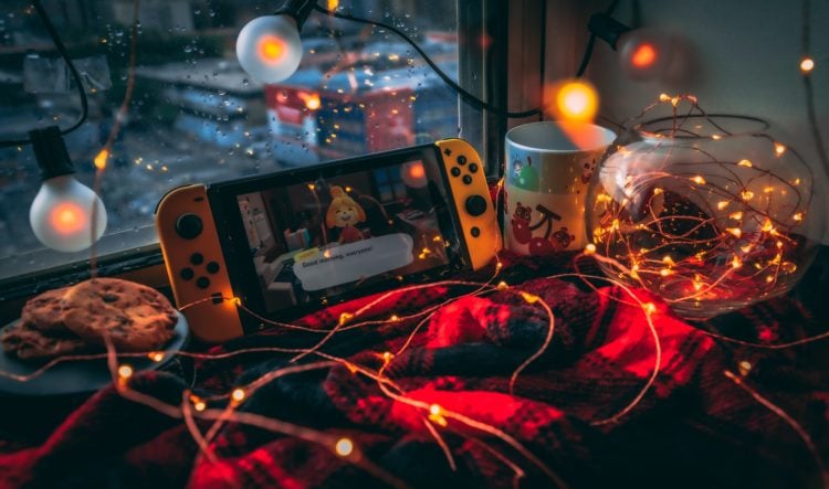 Nintendo switch on a blanket with fairy lights