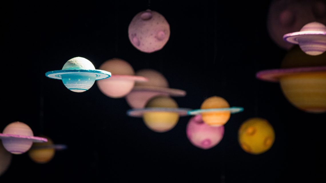 assorted planet decorations in blue pink and yellow