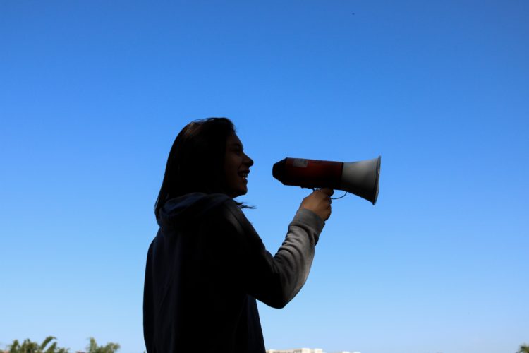 silhouette of person holding megaphone