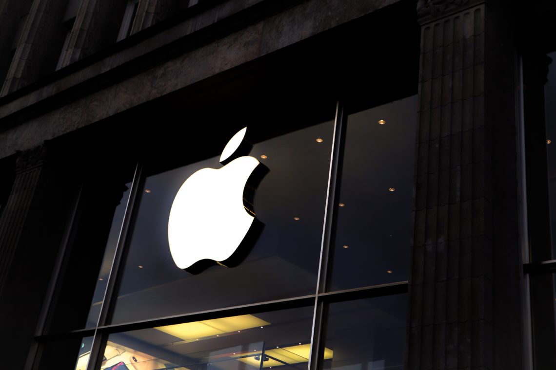 apple logo on glass front of store
