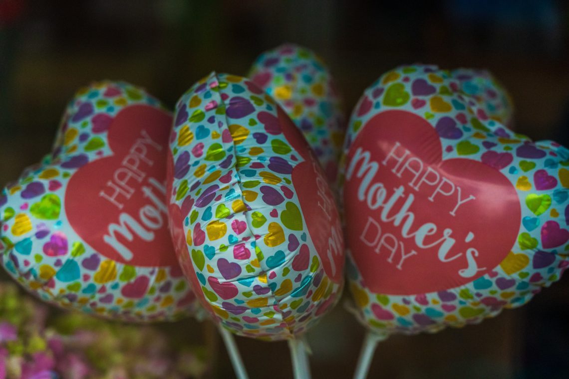 red and white happy bmothers day ballons shaped like a heart