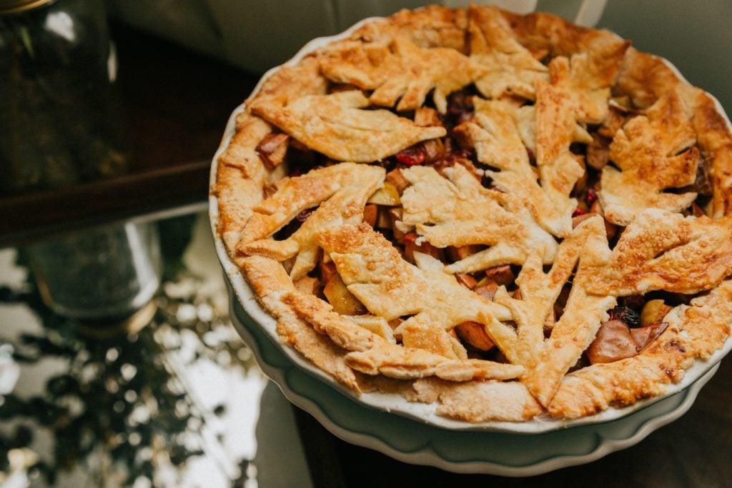 brown pie on white ceramic plate on countertop