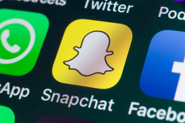 London, UK - July 30, 2018: The buttons of Snapchat, Facebook, WhatsApp, Twitter and other apps on the screen of an iPhone.