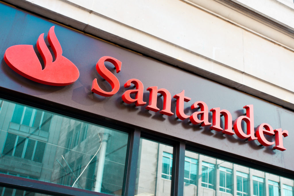 Close up of red santader sign on black building