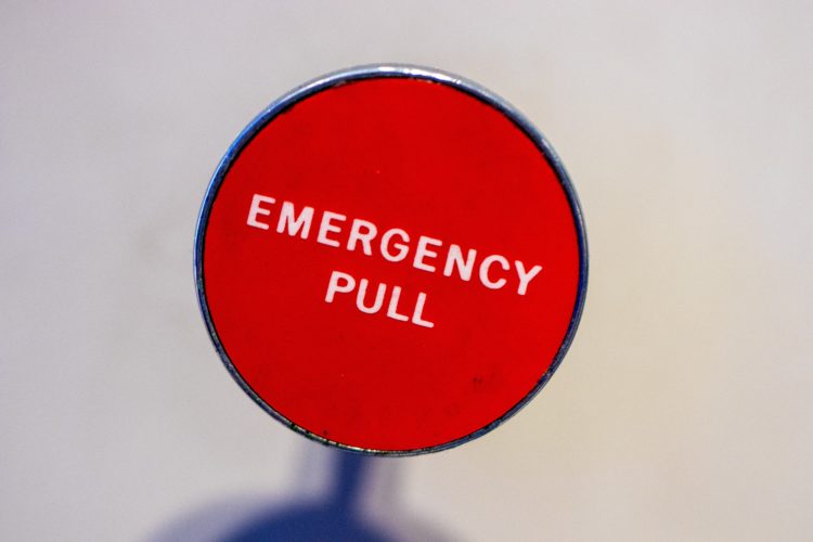 red Emergency Pull lever with white background