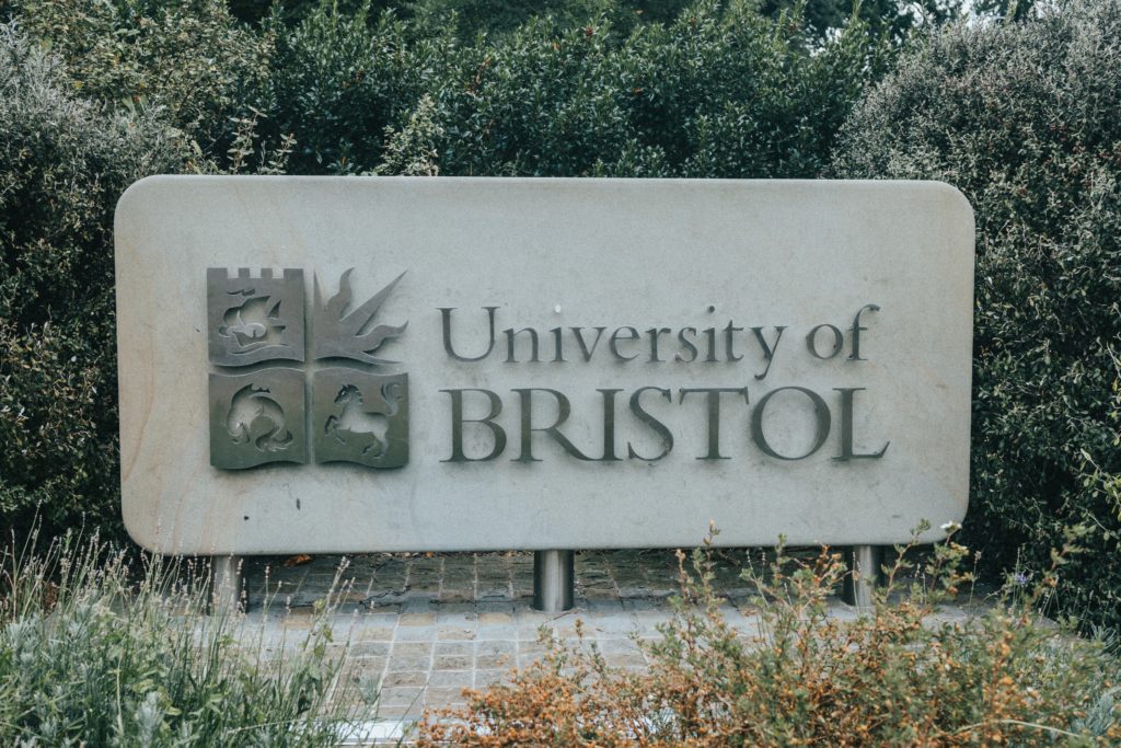 university of bristol sign amongst bushes