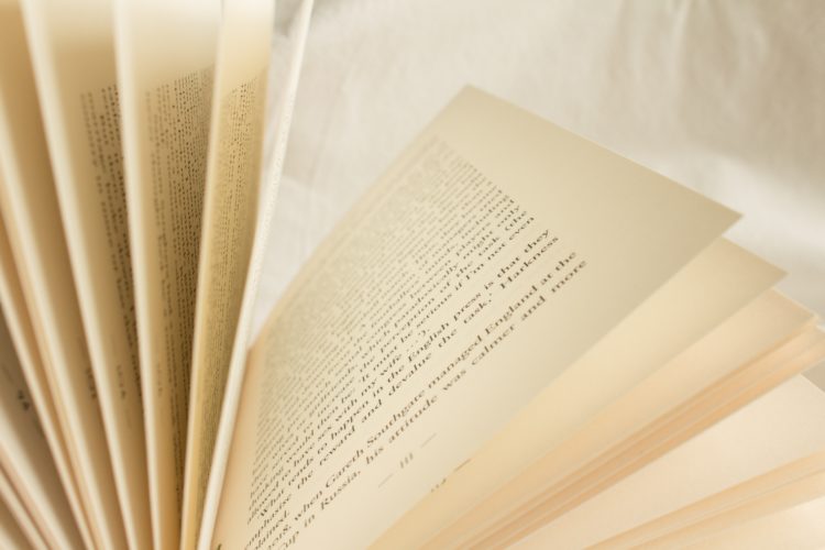 open pages of a book lying on a white sheet