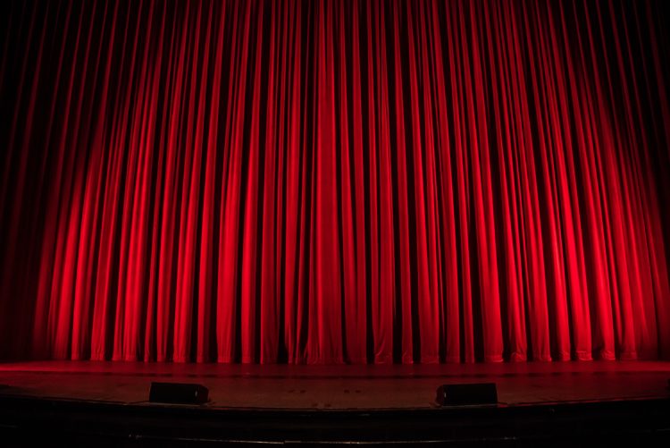 red curtain pulled on theatre stage