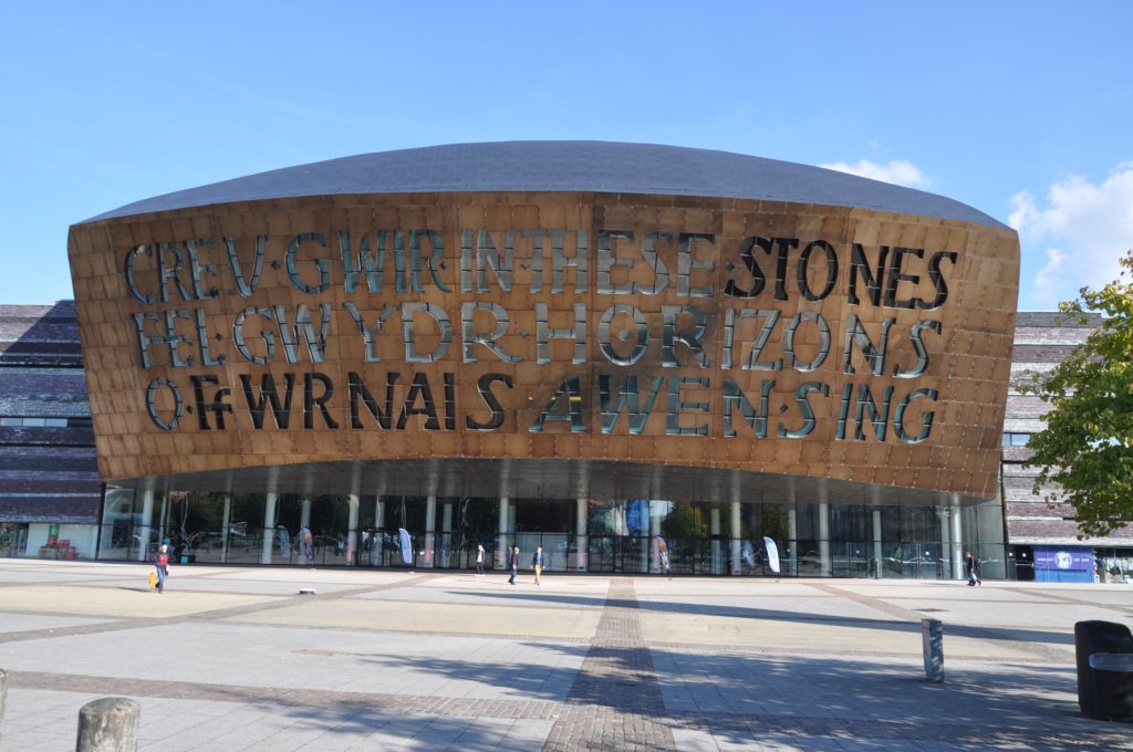 front of the wales millenium centre with people in front on sunny dat