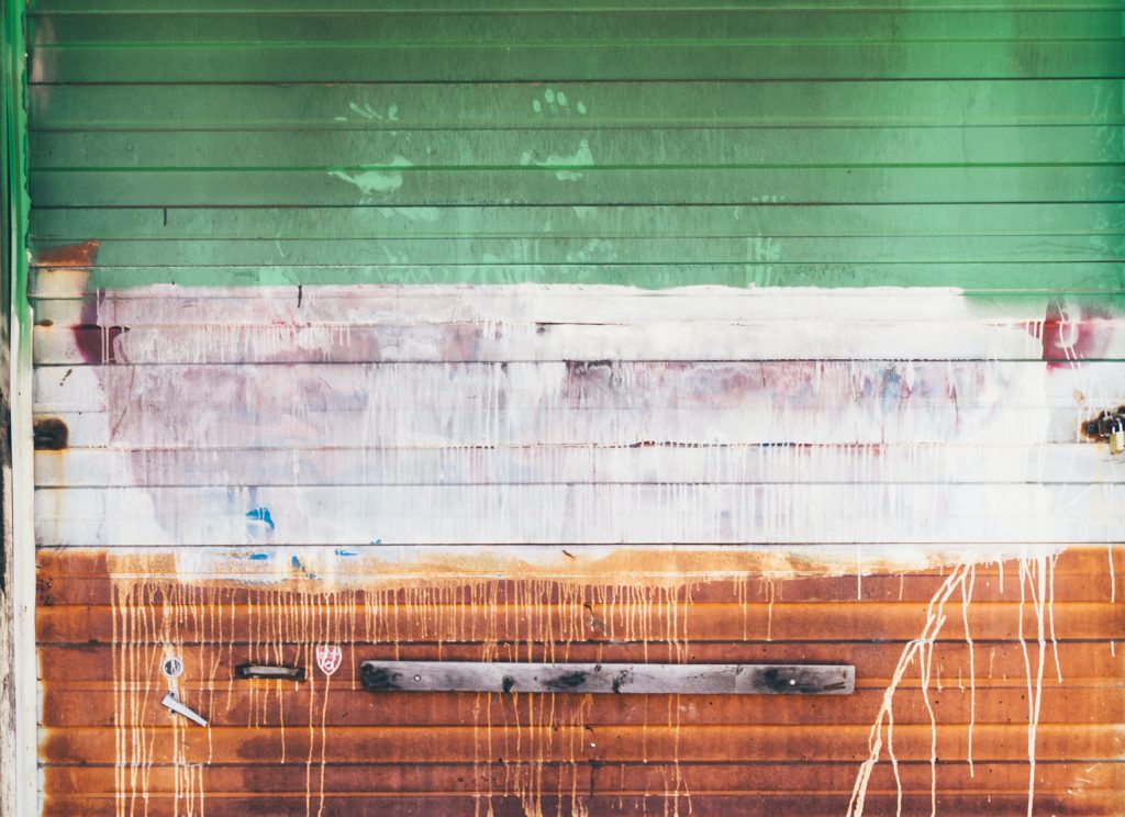 garage door painted haphazardly in the Irish flag