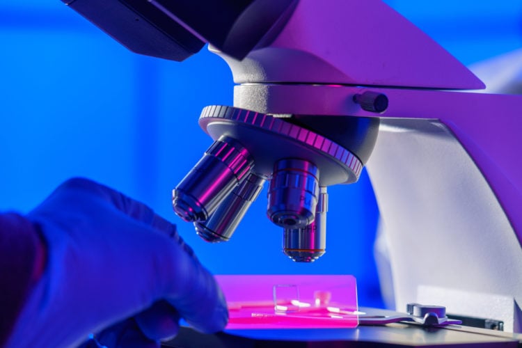 Researcher using a microscope.