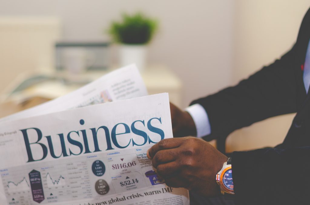 close up of man in suit reading business paper