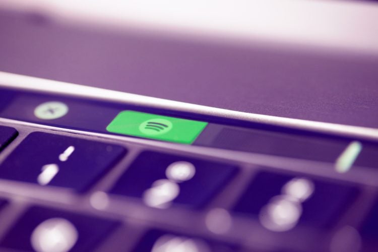 closeup photo of Spotify logo on macbook touch bar