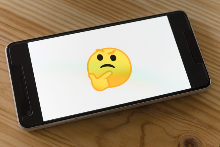 phone displayed thinking emoji on white background