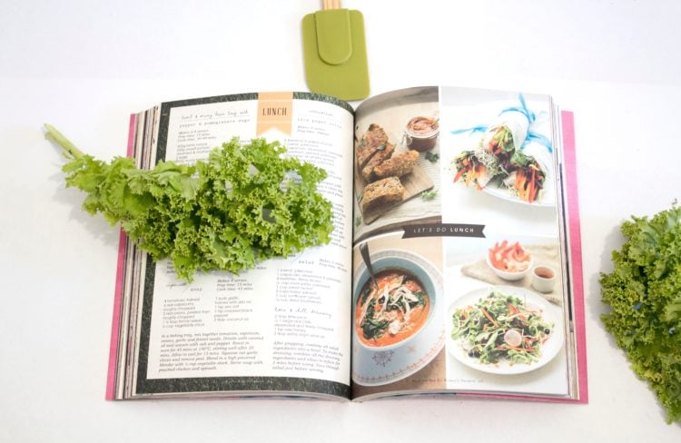 green leaf on open cookbook on white counter
